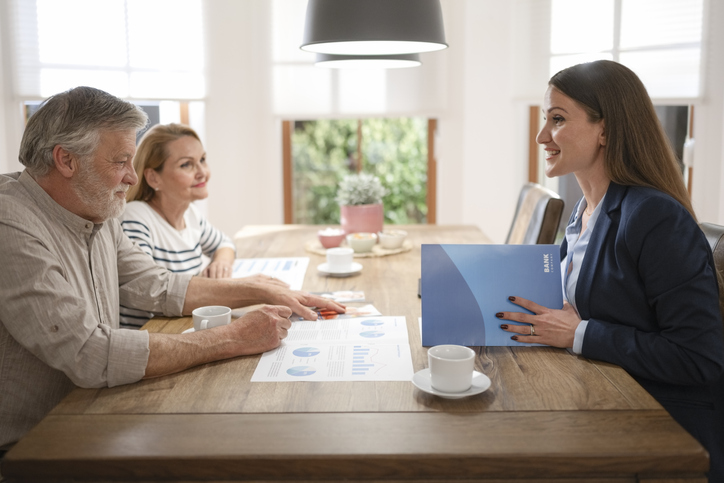 A couple meets with their financial planner to discuss how they might convert their IRAs into Roth IRAs.